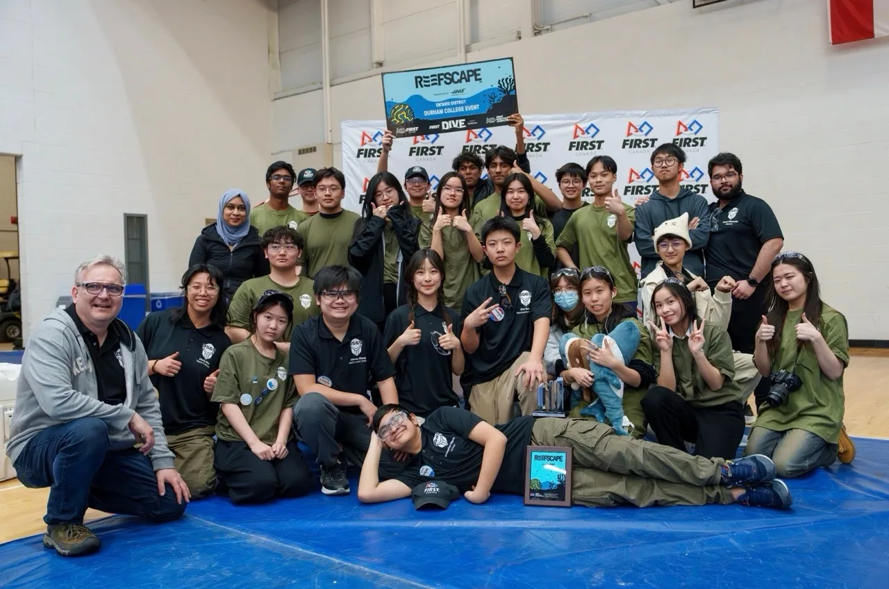 The 9569 Silver Knights team gathered together at a Durham College FRC event